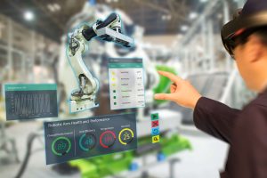 iot industry 4.0 concept,industrial engineer(blurred) using smart glasses with augmented reality mixed with virtual reality technology to monitoring machine in real time. Smart factory use Automation robot arm